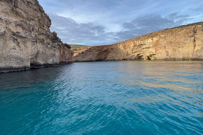 Blue Lagoon Ferry and Caves Tour - Meeting Under the Blue Umbrella at Mgarr Gozo