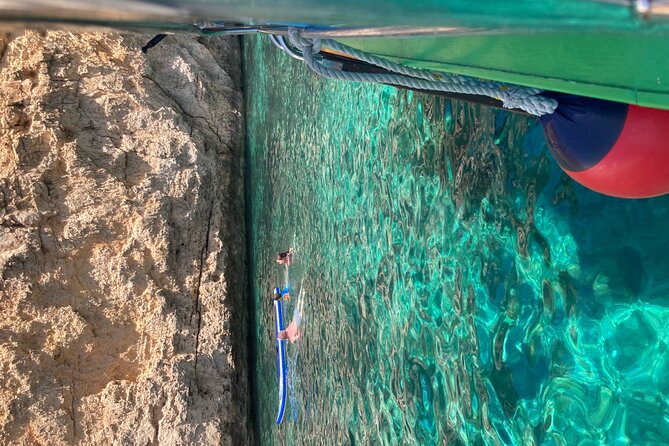 Comino Private Boat with Snorkeling and Cave Sightseeing - Santa Maria Caves: Cave Pond Swim and a Classic Film Detail