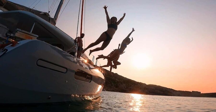 Evening Catamaran Charter - The Cruise Part: Music, City Lights, and Easy Sightseeing Time