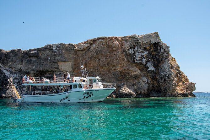 Three Bay Cruise Including Blue Lagoon from Mellieha - Crystal Lagoon on Comino: cliffs, shelter, and sea-cave views